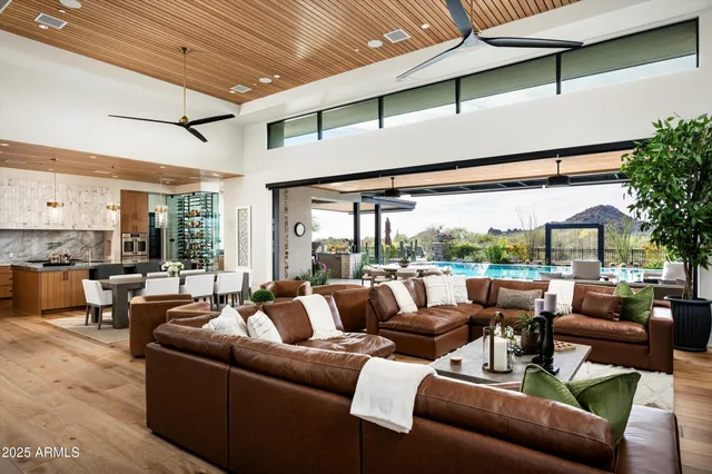 a spacious bedroom with a bed couch and a large window