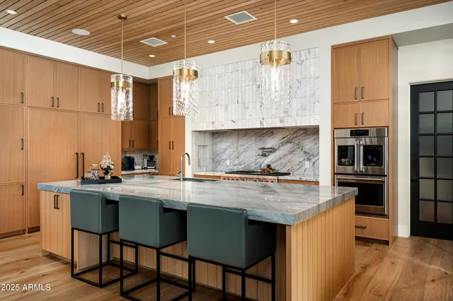 a kitchen with granite countertop a sink and cabinets
