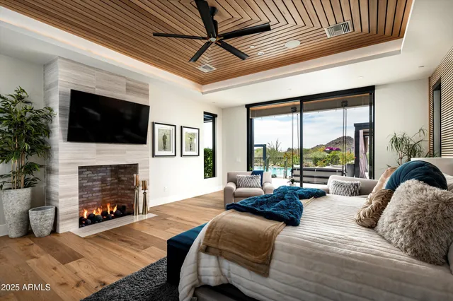 a bedroom with a large bed and wooden floor