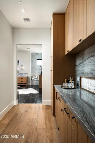 a roof deck with table and chairs under an umbrella