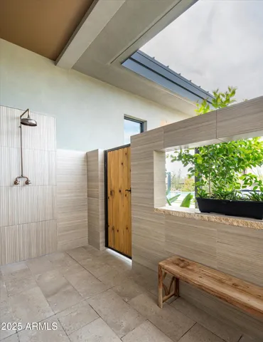 a living room with furniture a fireplace and a floor to ceiling window