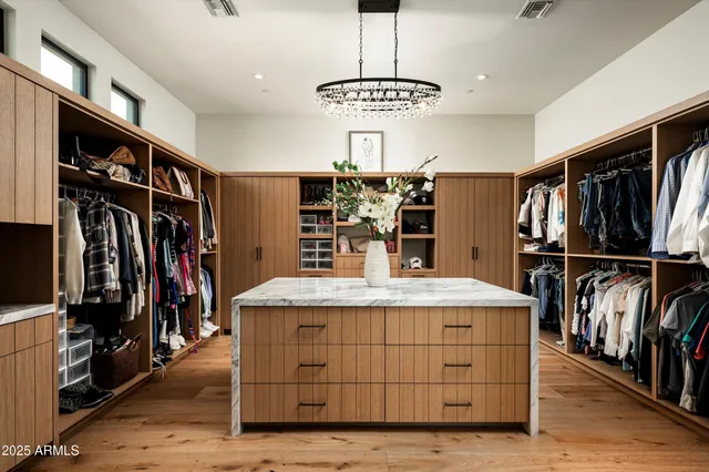 a view of a chairs and table in the back yard of the house