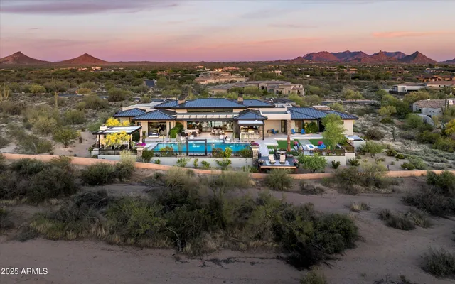 a view of a patio with couches table and chairs potted plants with wooden floor and fence