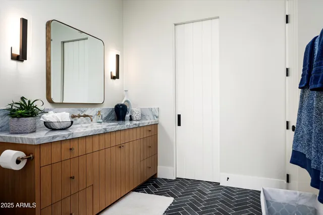 a kitchen with stainless steel appliances kitchen island granite countertop a table and chairs in it