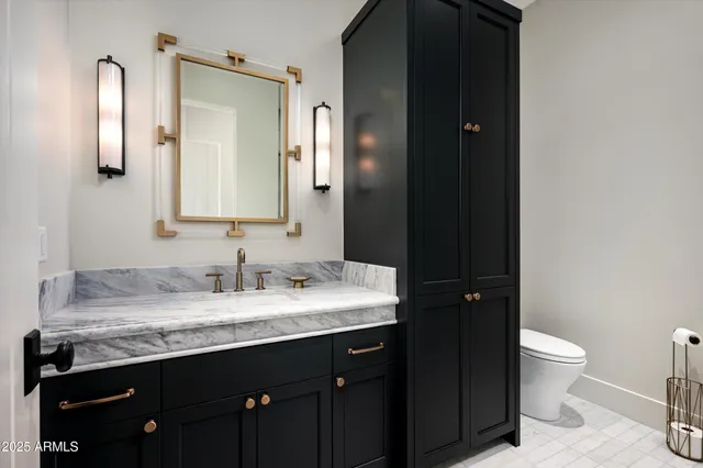 a patio with table and chairs and potted plants