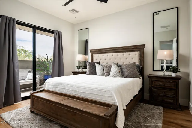 a view of a patio with table and chairs potted plants and a large tree