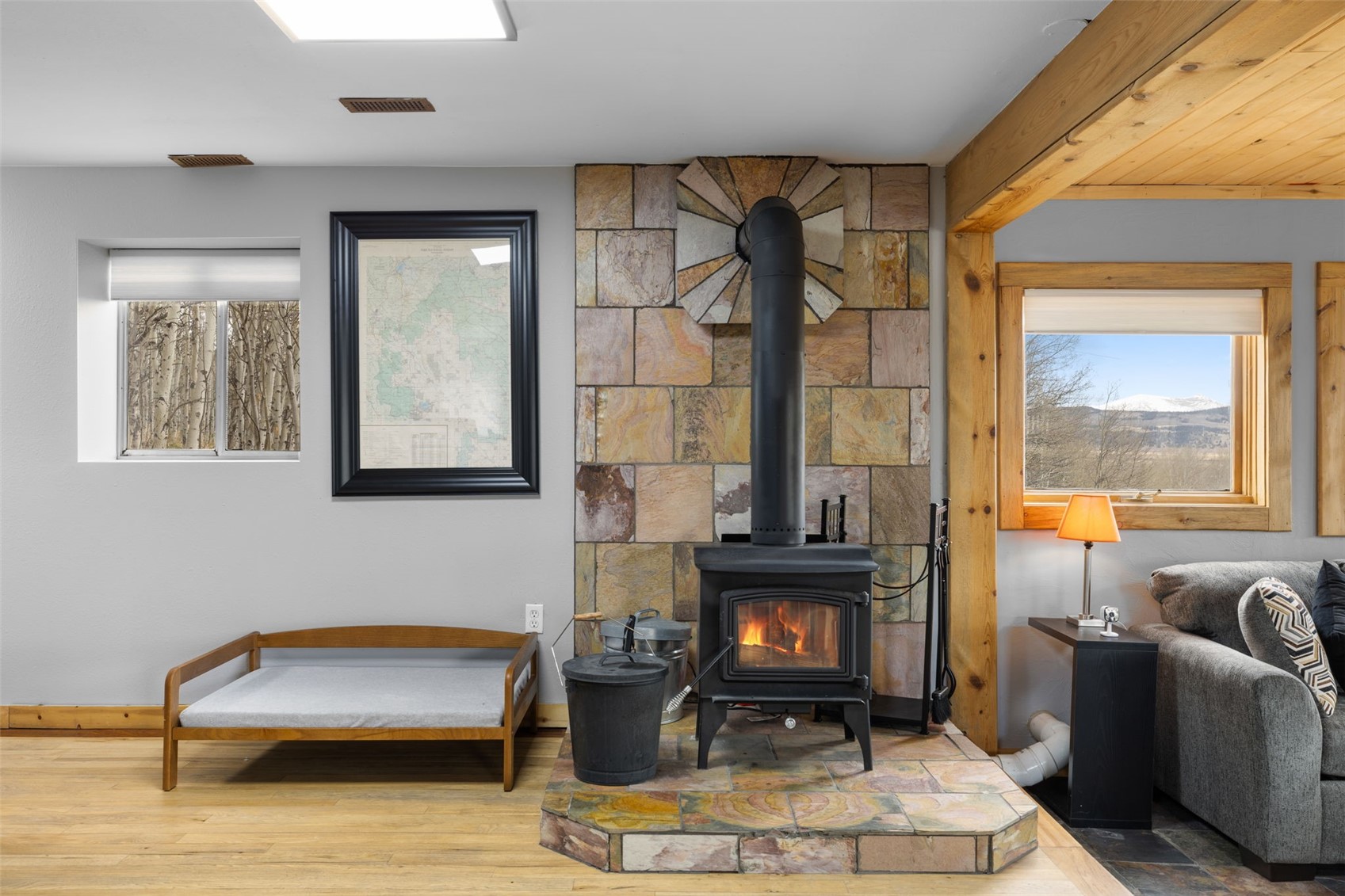 2349 Michigan Hill Road Jefferson, CO 80456 - Photo 23 of 33 a living room with furniture a fireplace and a large window