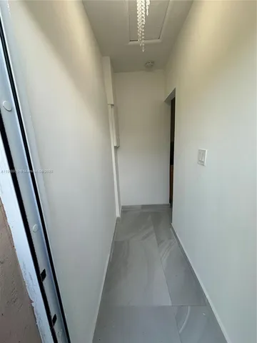 wooden floor in an empty room with a mirror