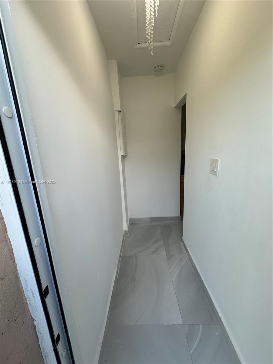 707 Northeast 15th Street, Unit C Fort Lauderdale, FL 33304 - Photo 2 of 6 wooden floor in an empty room with a mirror