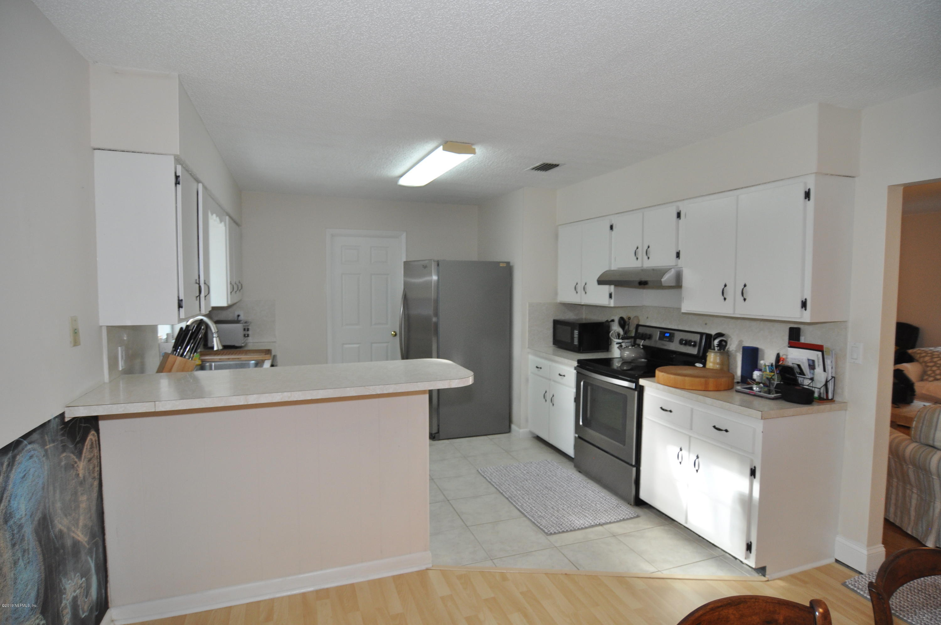 348 Jasmine Road St. Augustine, FL 32086 - Photo 6 of 15 a kitchen with a sink a stove and refrigerator