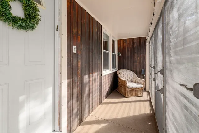 a bedroom with a bed and a view of living room