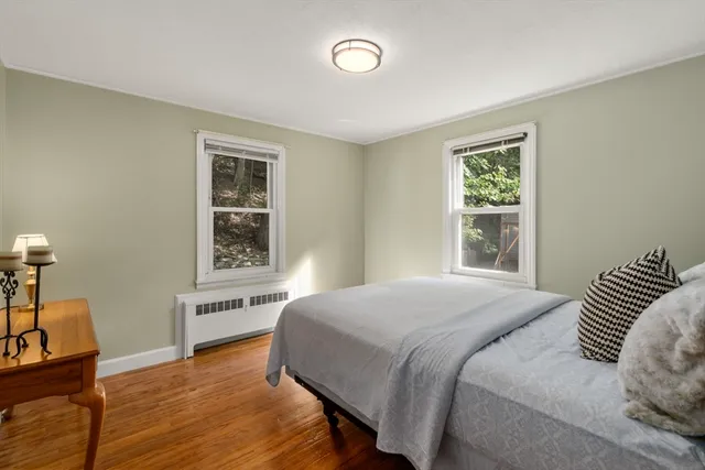 a bedroom with a bed and a potted plant