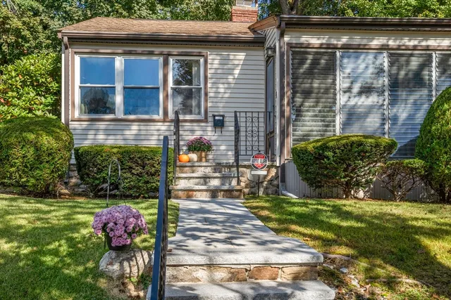 a front view of a house with garden