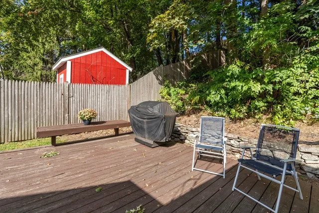a view of a backyard with table and chairs and potted plants