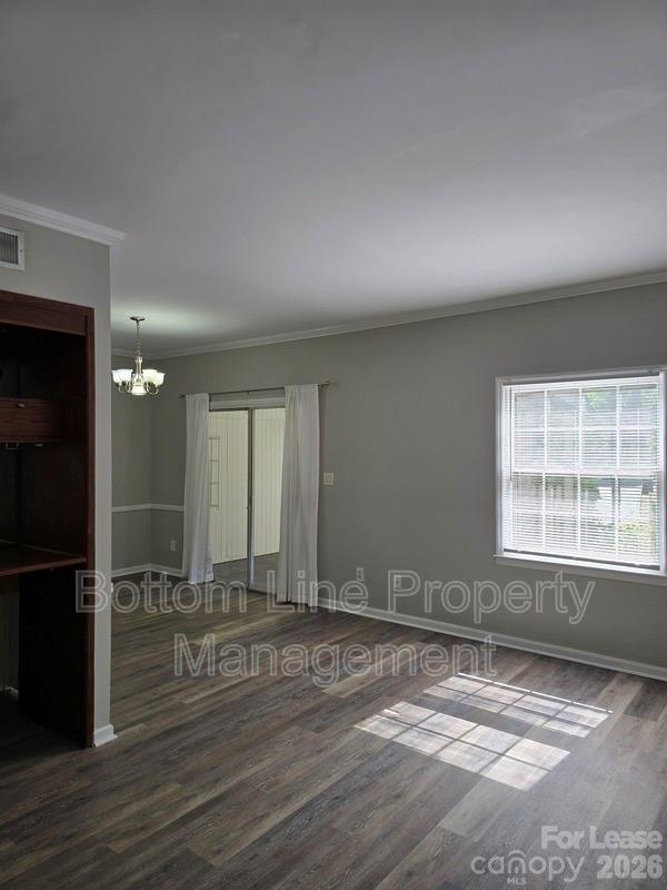 5949 Quail Hollow Road, Unit D Charlotte, NC 28210 - Photo 4 of 34 an empty room with wooden floor and windows