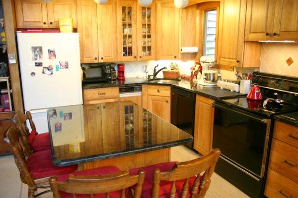 70 Tyringham Road Monterey, MA 01245 - Photo 16 of 22 a kitchen with stainless steel appliances kitchen island granite countertop a refrigerator and a stove top oven