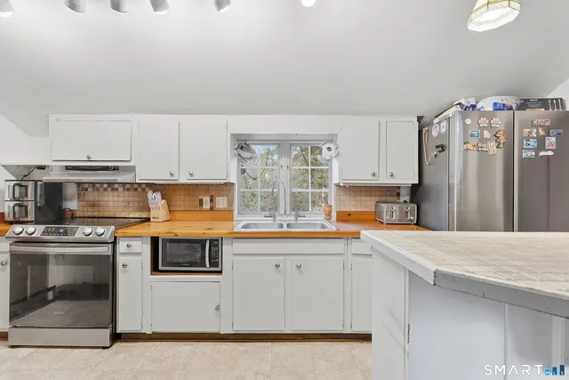 a kitchen with a refrigerator a sink and a stove