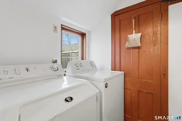 a living room with furniture a wooden floor and a large window