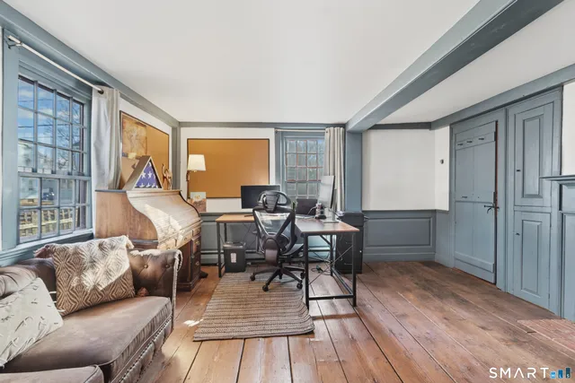 a workspace with furniture window and wooden floor