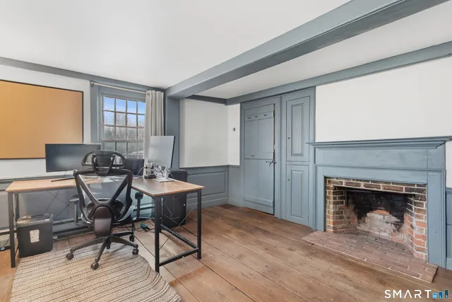 a living room with furniture and large windows