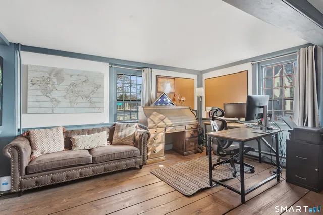 a bedroom with a bed and a wooden floor