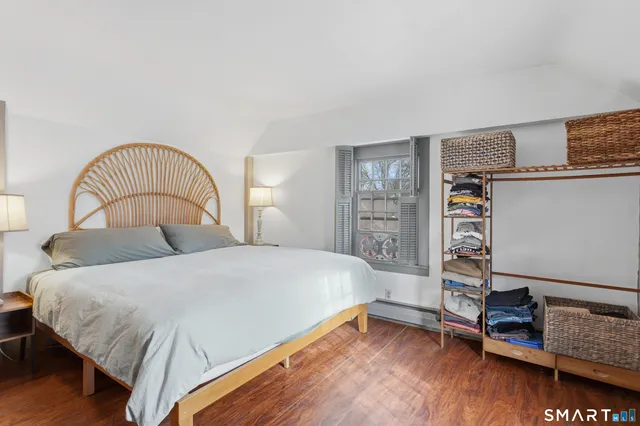 a bedroom with a bed and a large window