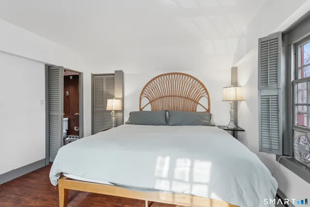 a white toilet sitting next to a bathroom sink and a tub