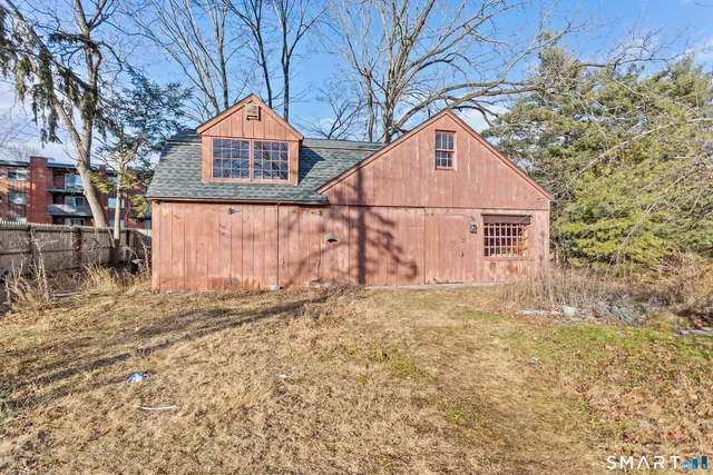 a backyard of a house with table and chairs