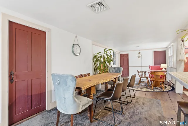 a view of dining room and kitchen with furniture wooden floor and a chandelier