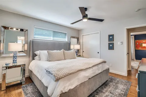 a large bedroom with a bed and a chandelier