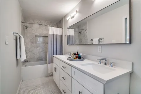 a bathroom with a sink mirror toilet and bathtub