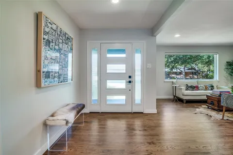 a view of a livingroom with furniture and a window