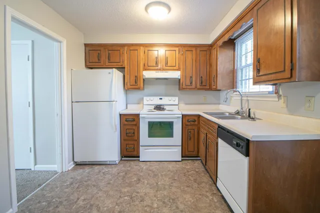 a kitchen with a refrigerator sink and stove