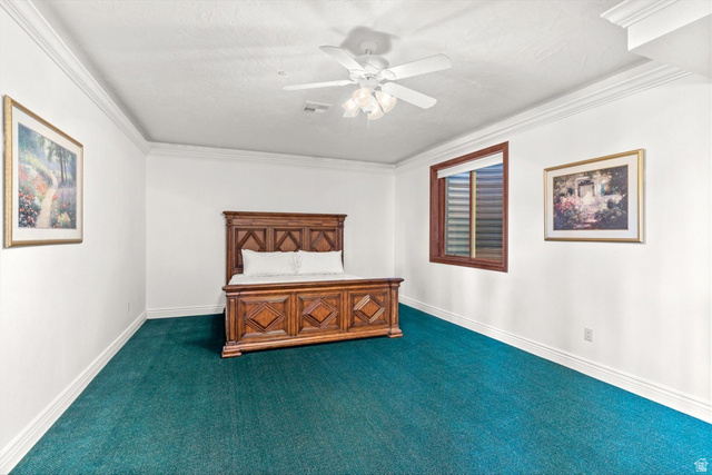 5615 East Eight Mile Gap Road Kanab, UT 84741 - Photo 57 of 81 Unfurnished bedroom with ceiling fan, ornamental molding, and dark carpet