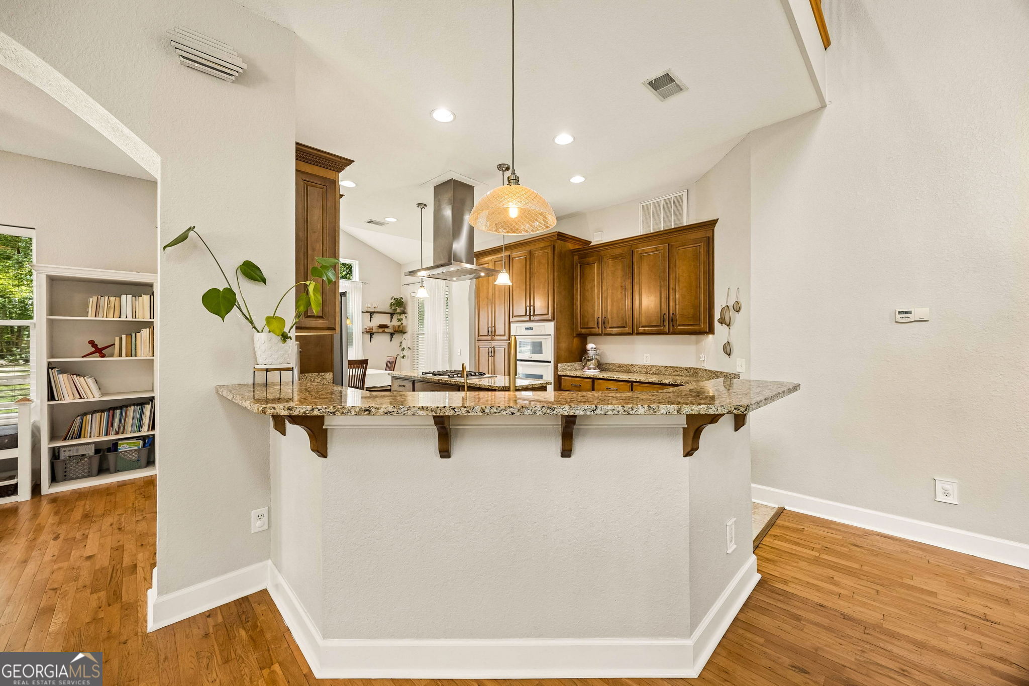 706 Hopewell Point Road White Oak, GA 31568 - Photo 14 of 84 Designed for both daily living and entertaining, the kitchen features granite countertops, abundant cabinetry, a large breakfast bar, and direct connection to the main living spaces.