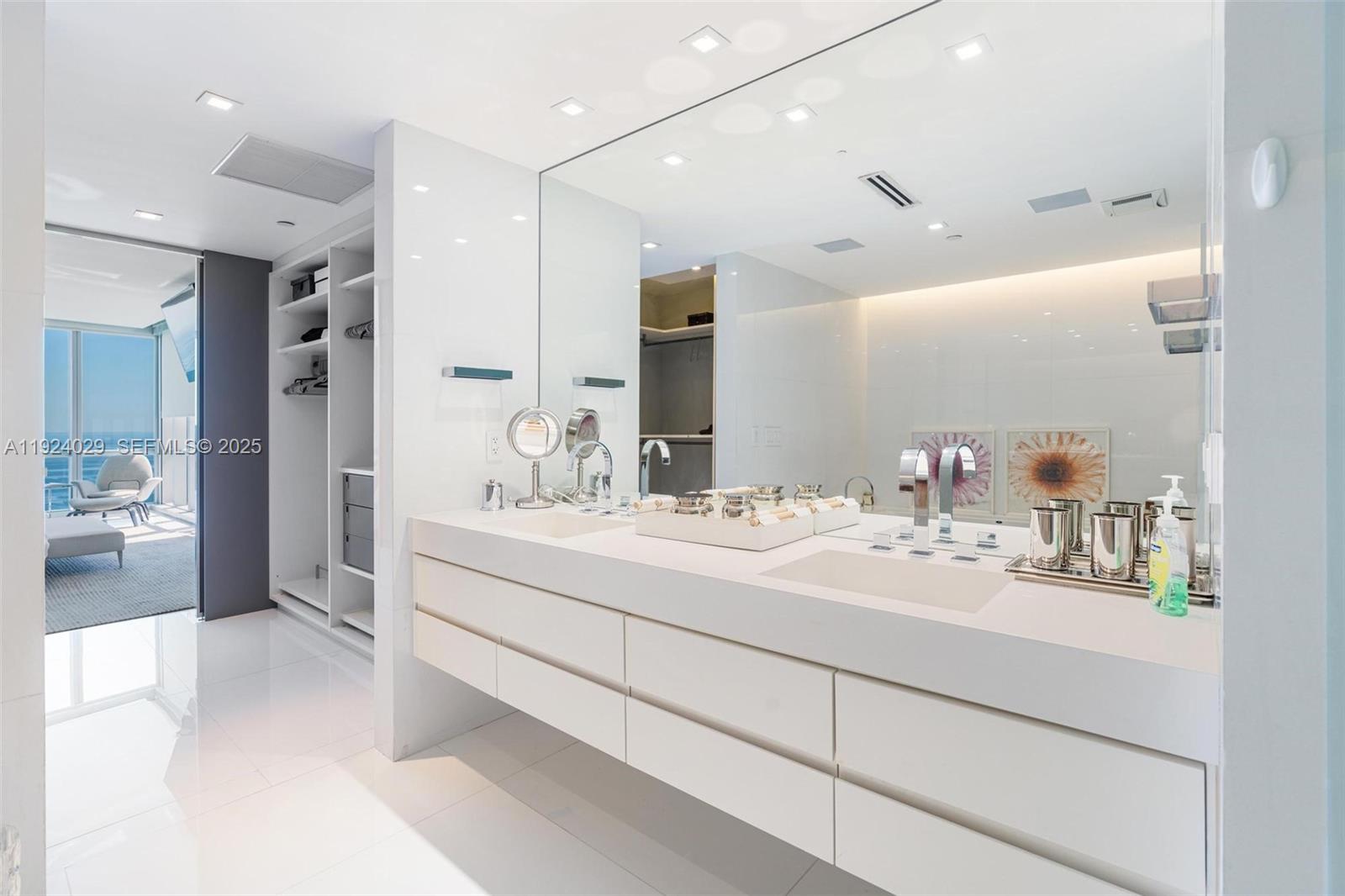 17121 Collins Avenue, Unit 3201 Sunny Isles Beach, FL 33160 - Photo 12 of 36 a bathroom with a double vanity sink mirror and double