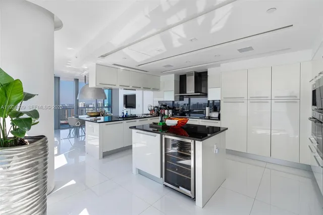 a kitchen with stainless steel appliances a refrigerator and a sink