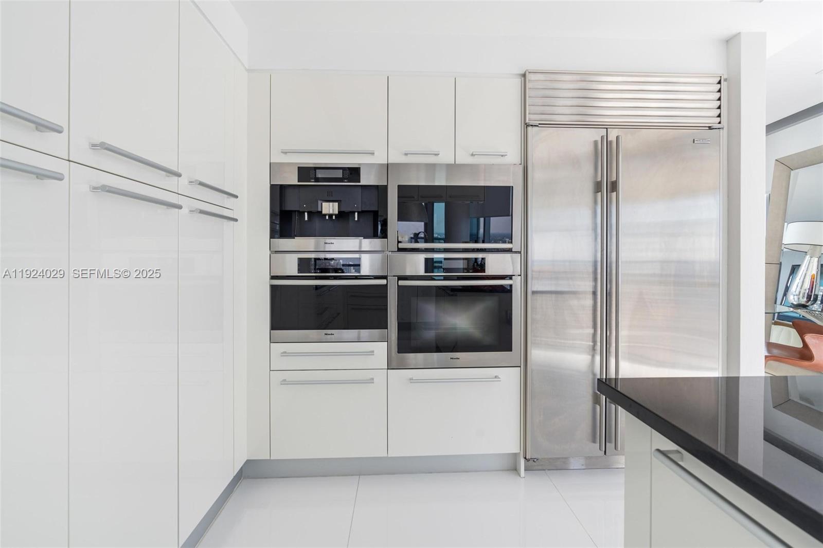 17121 Collins Avenue, Unit 3201 Sunny Isles Beach, FL 33160 - Photo 16 of 36 a kitchen with stainless steel appliances a refrigerator and a sink