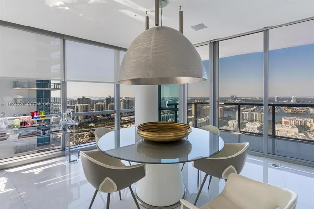 a kitchen with stainless steel appliances kitchen island granite countertop a plate of food and a chair