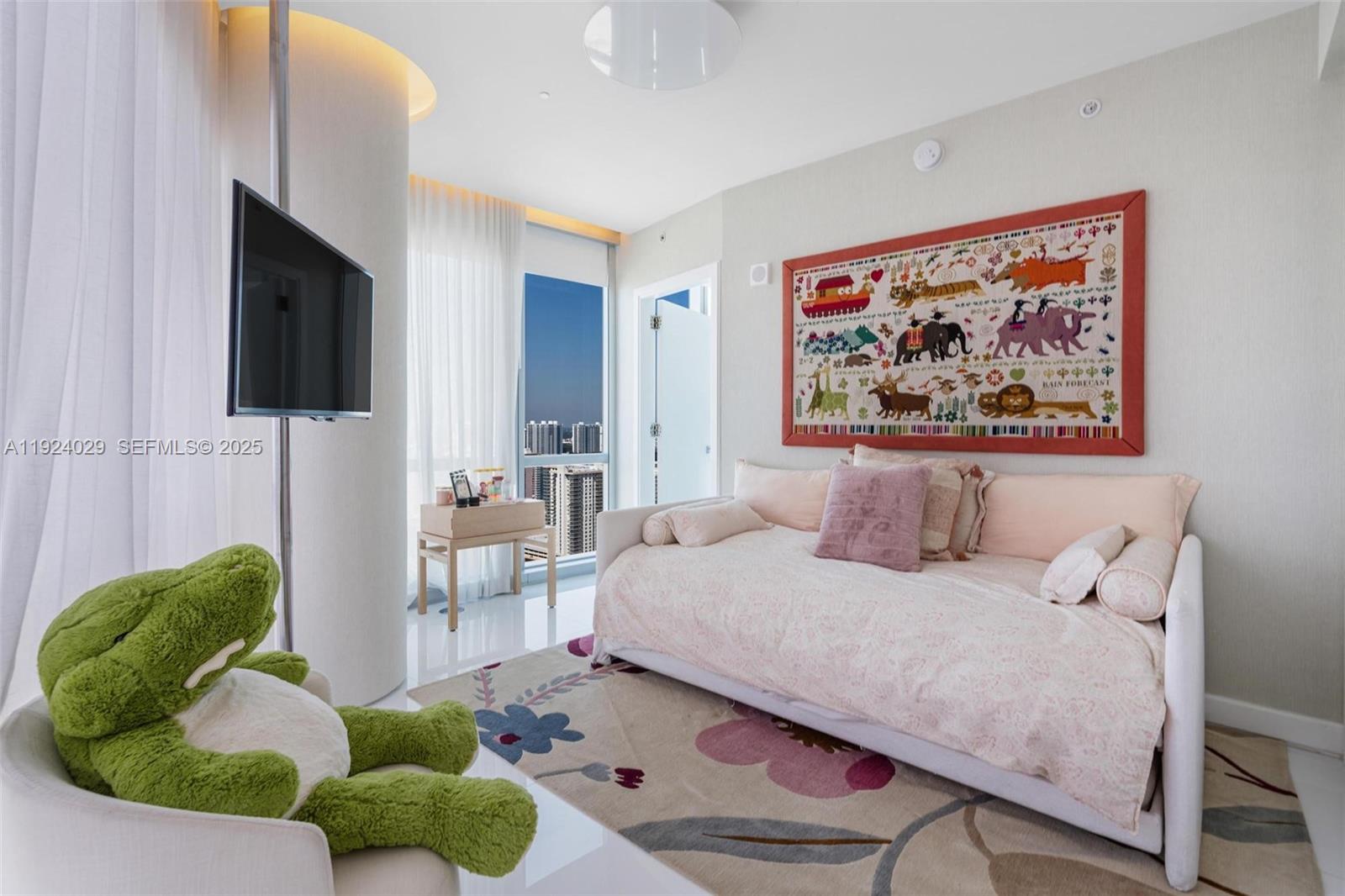 17121 Collins Avenue, Unit 3201 Sunny Isles Beach, FL 33160 - Photo 21 of 36 a bedroom with a bed and a flat screen tv