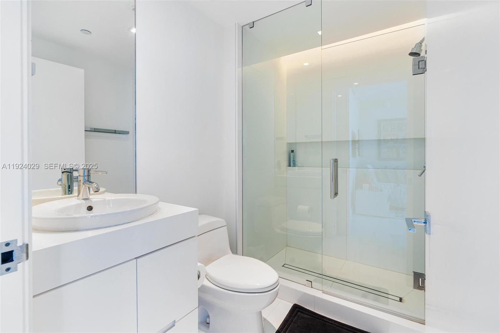 17121 Collins Avenue, Unit 3201 Sunny Isles Beach, FL 33160 - Photo 24 of 36 a bathroom with a sink toilet and shower