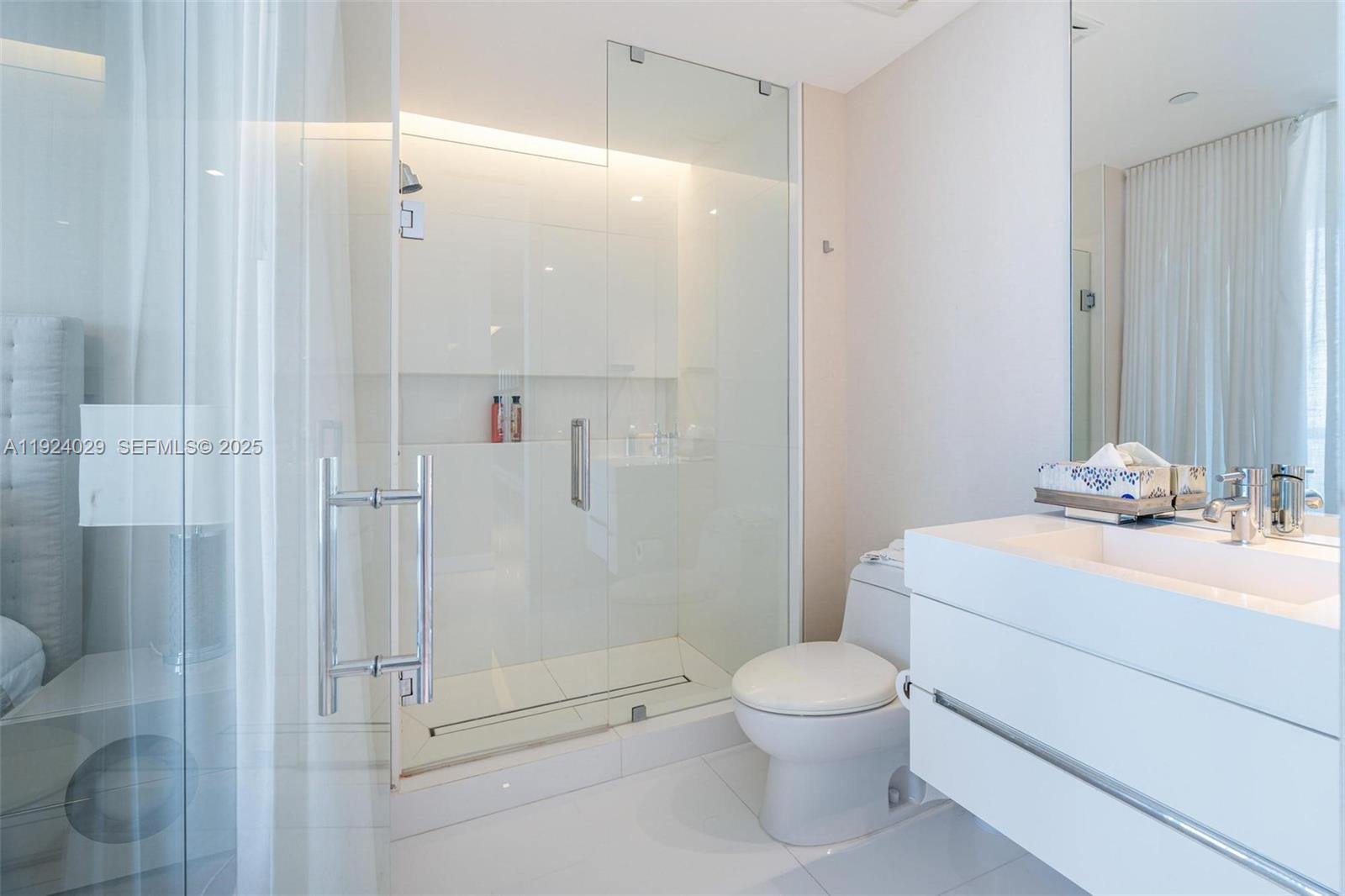 17121 Collins Avenue, Unit 3201 Sunny Isles Beach, FL 33160 - Photo 26 of 36 a bathroom with a toilet a sink and shower