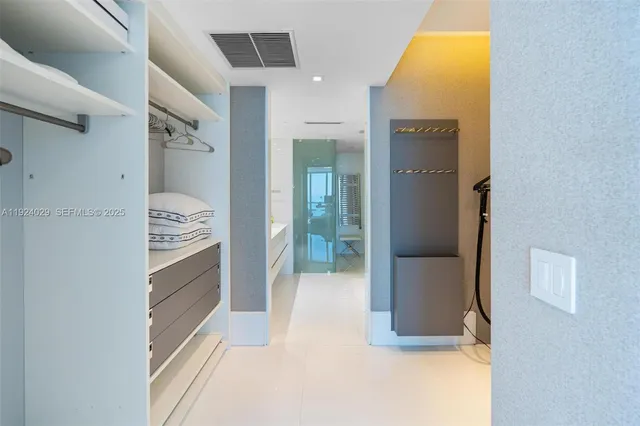 a en suite bathroom with a double vanity sink toilet mirror and bathtub