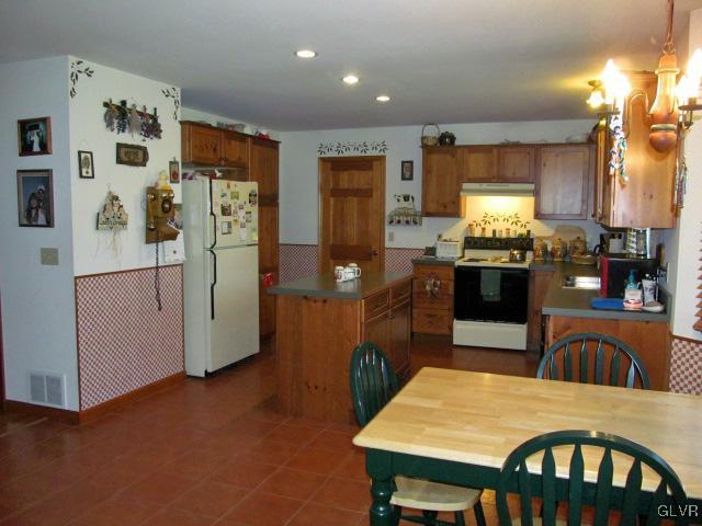 400 Heyer Mill Road Nazareth, PA 18064 - Photo 12 of 27 a kitchen with stainless steel appliances granite countertop a refrigerator a stove top oven a sink dishwasher and white cabinets with wooden floor