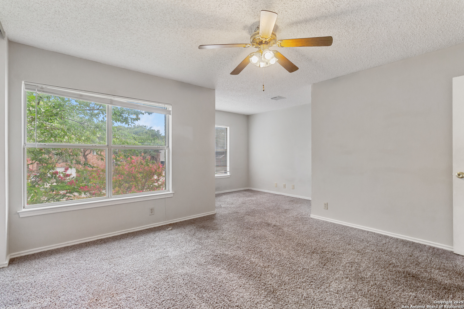 8310 Border Ridge Drive San Antonio, TX 78240 - Photo 14 of 24 an empty room with windows and outdoor view