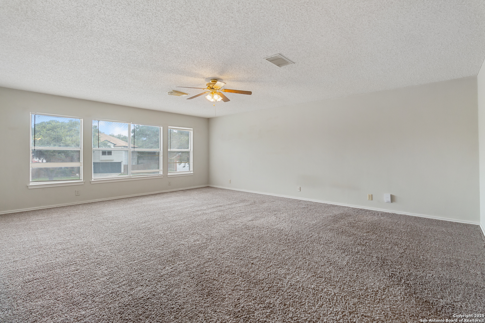 8310 Border Ridge Drive San Antonio, TX 78240 - Photo 18 of 24 a view of an empty room with a window