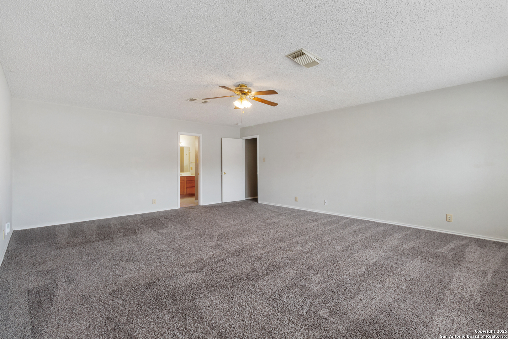 8310 Border Ridge Drive San Antonio, TX 78240 - Photo 19 of 24 a view of an empty room with a chandelier fan