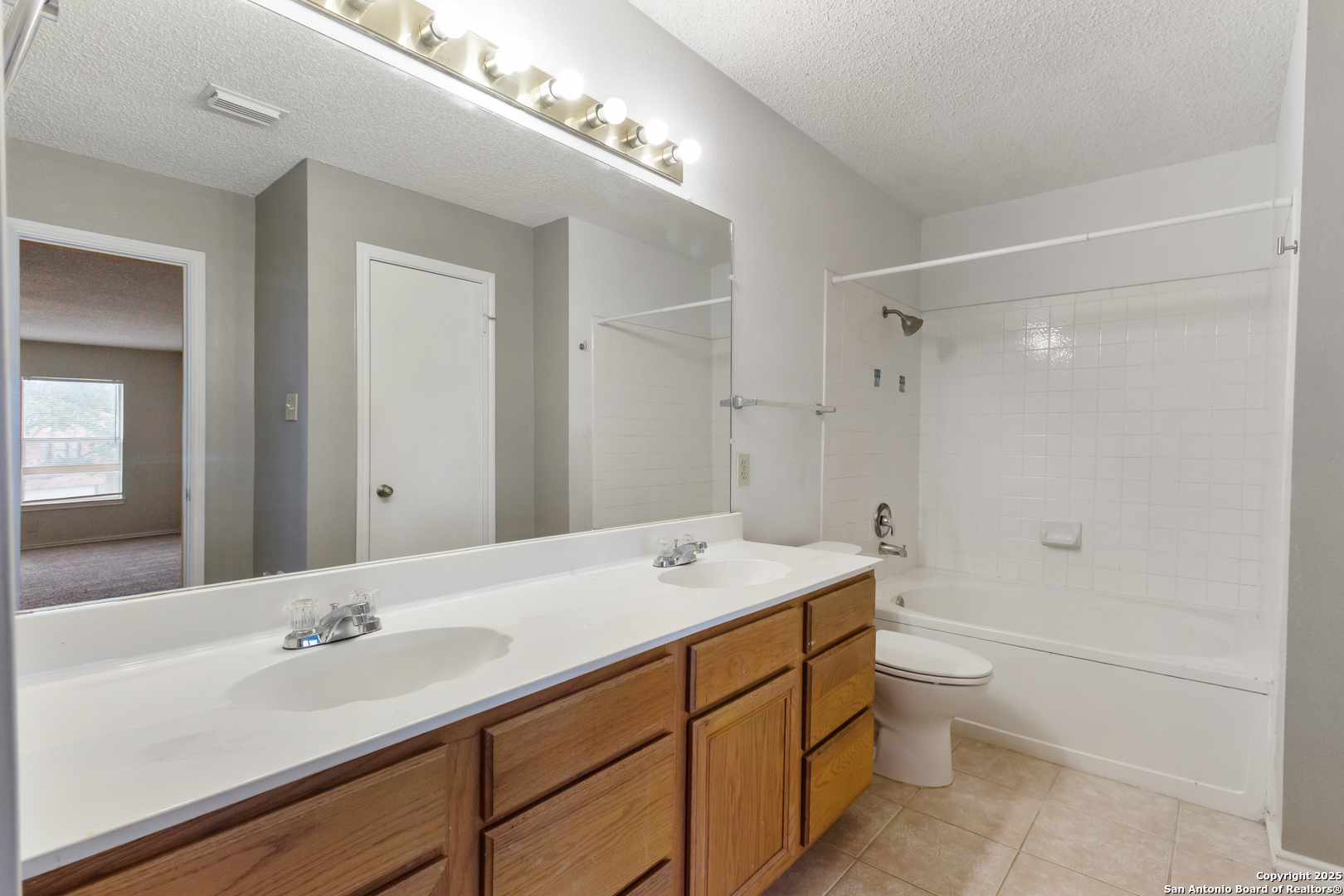 8310 Border Ridge Drive San Antonio, TX 78240 - Photo 20 of 24 a bathroom with a sink a toilet and shower