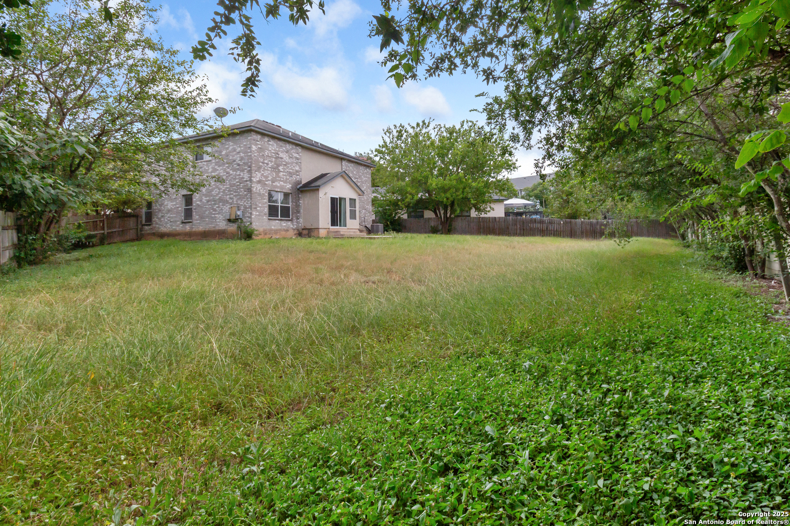 8310 Border Ridge Drive San Antonio, TX 78240 - Photo 23 of 24 a aerial view of a house with a big yard