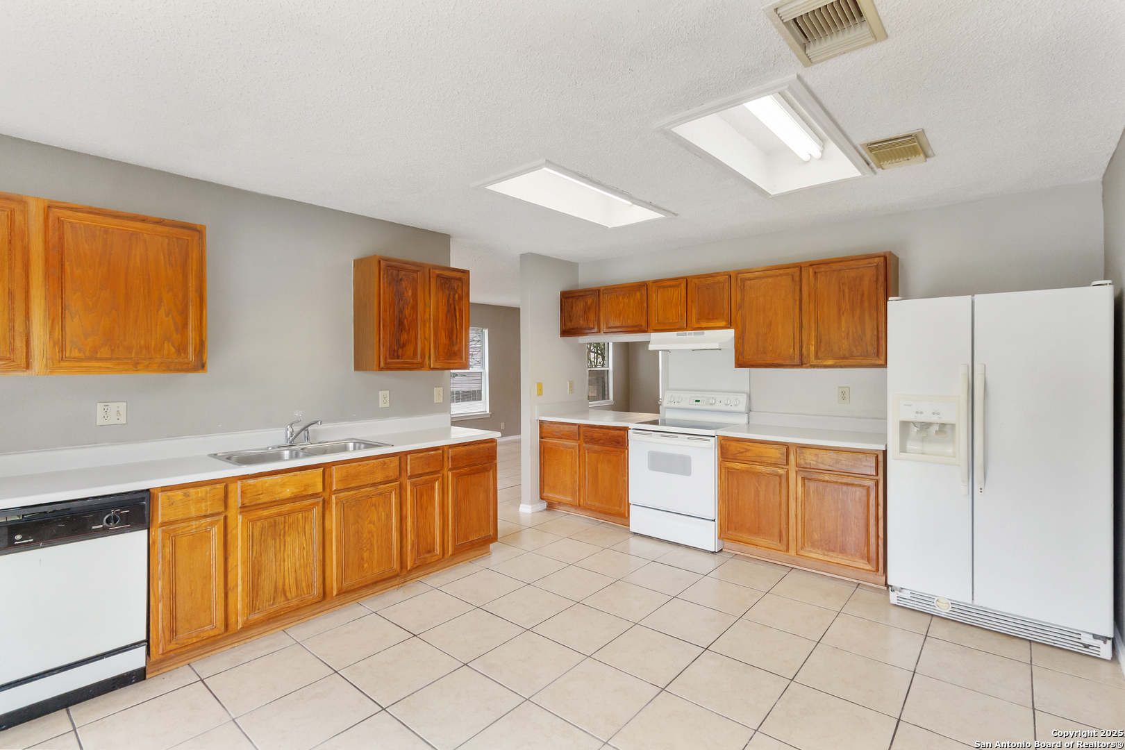 8310 Border Ridge Drive San Antonio, TX 78240 - Photo 9 of 24 a large kitchen with stainless steel appliances granite countertop a sink and cabinets